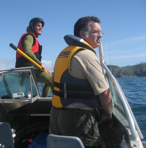 William (front) skippering the DOC boat helping to disentangle a humpback whale with DOC staff member Mike Morrissey.